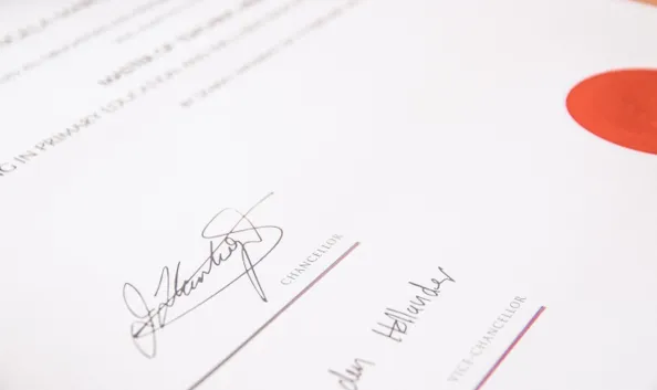 Close-up of a signed certificate with a red seal, representing life coach training, accreditation, and professional certification.