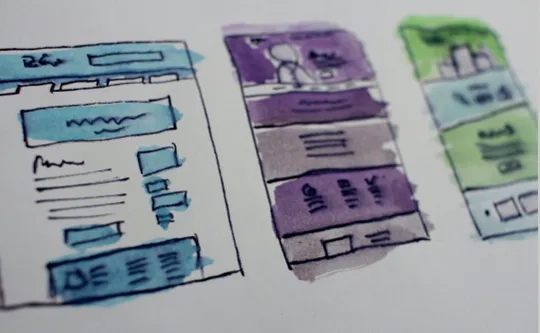 Hand-drawn website wireframes with colorful watercolor accents, symbolizing the importance of designing a professional website for coaches.