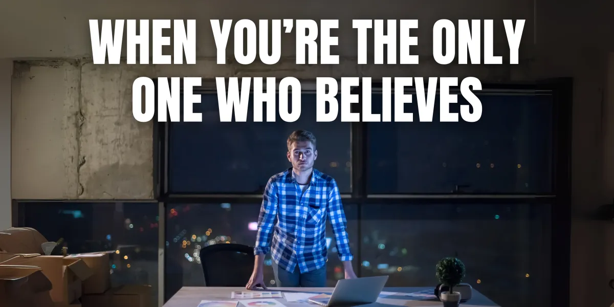 A person standing confidently alone, symbolizing belief and leadership in their vision.