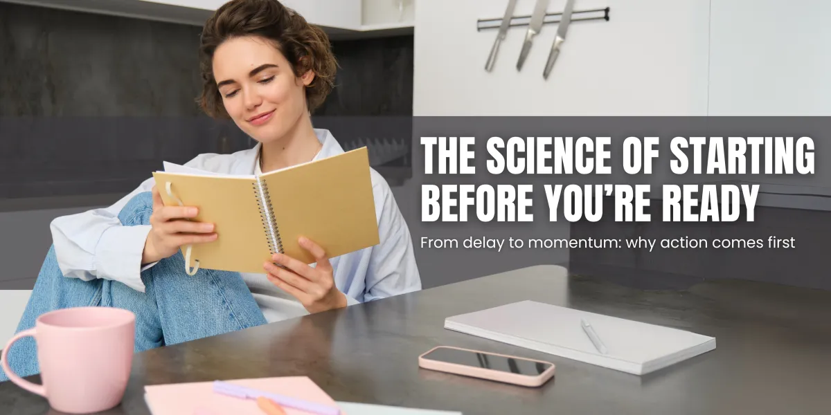 Woman sitting at a kitchen table, smiling while reading a notebook. A pink mug, smartphone, and notepad with a pen are on the table. Text overlay reads: 'The Science of Starting Before You’re Ready – From delay to momentum: why action comes first.