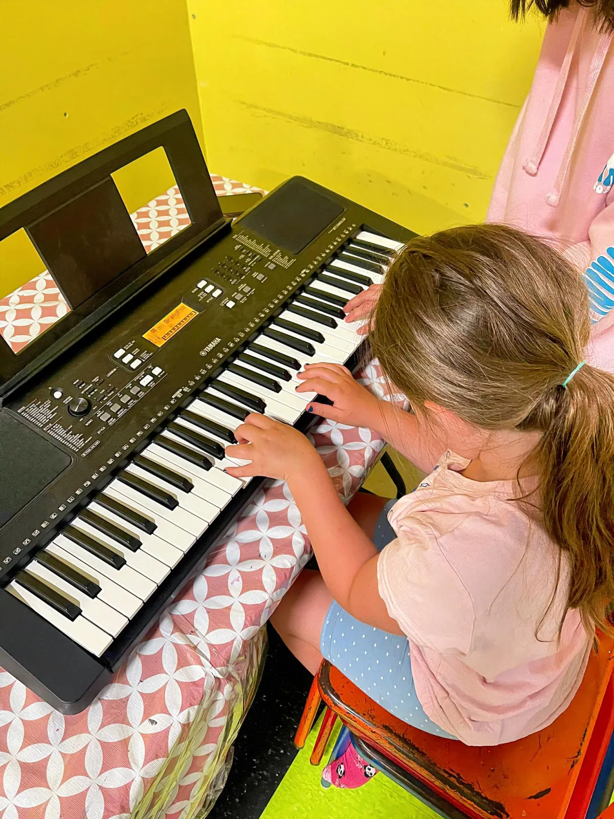 girl child playing piano