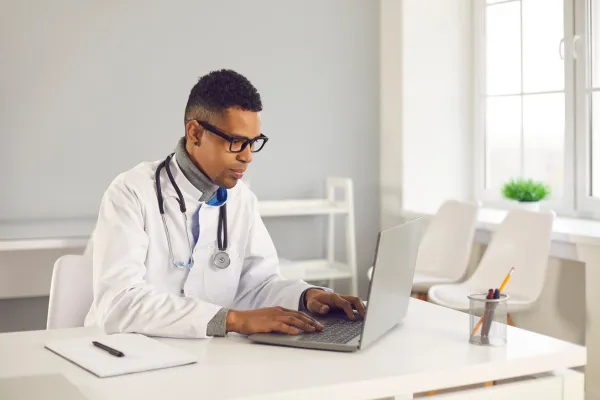 Healthcare provider reviewing automated appointment reminders to improve patient reliability.