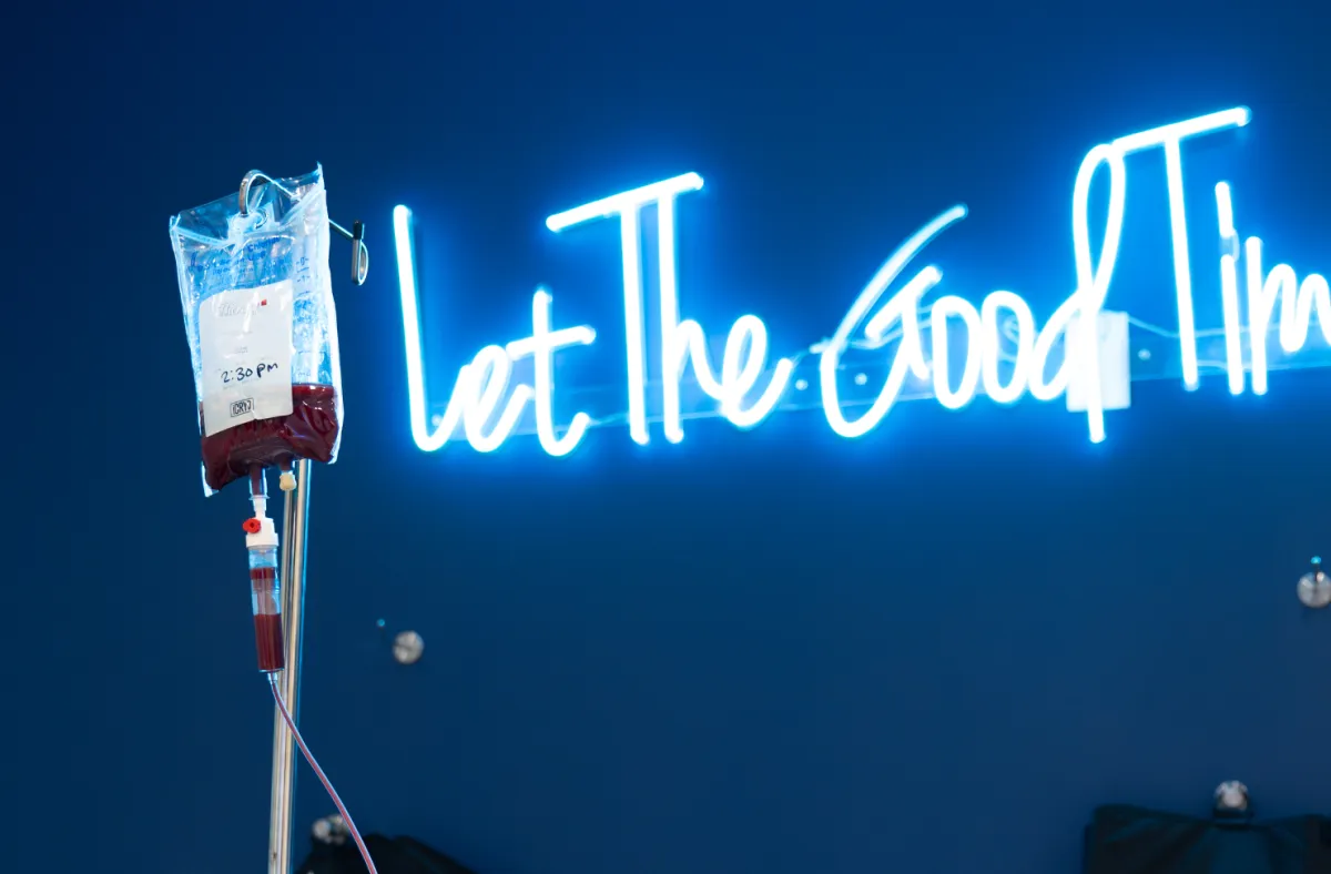 An iV bag hanging in a room with a led sign