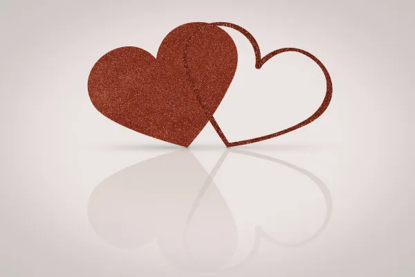 2 red hearts over lapping on white background