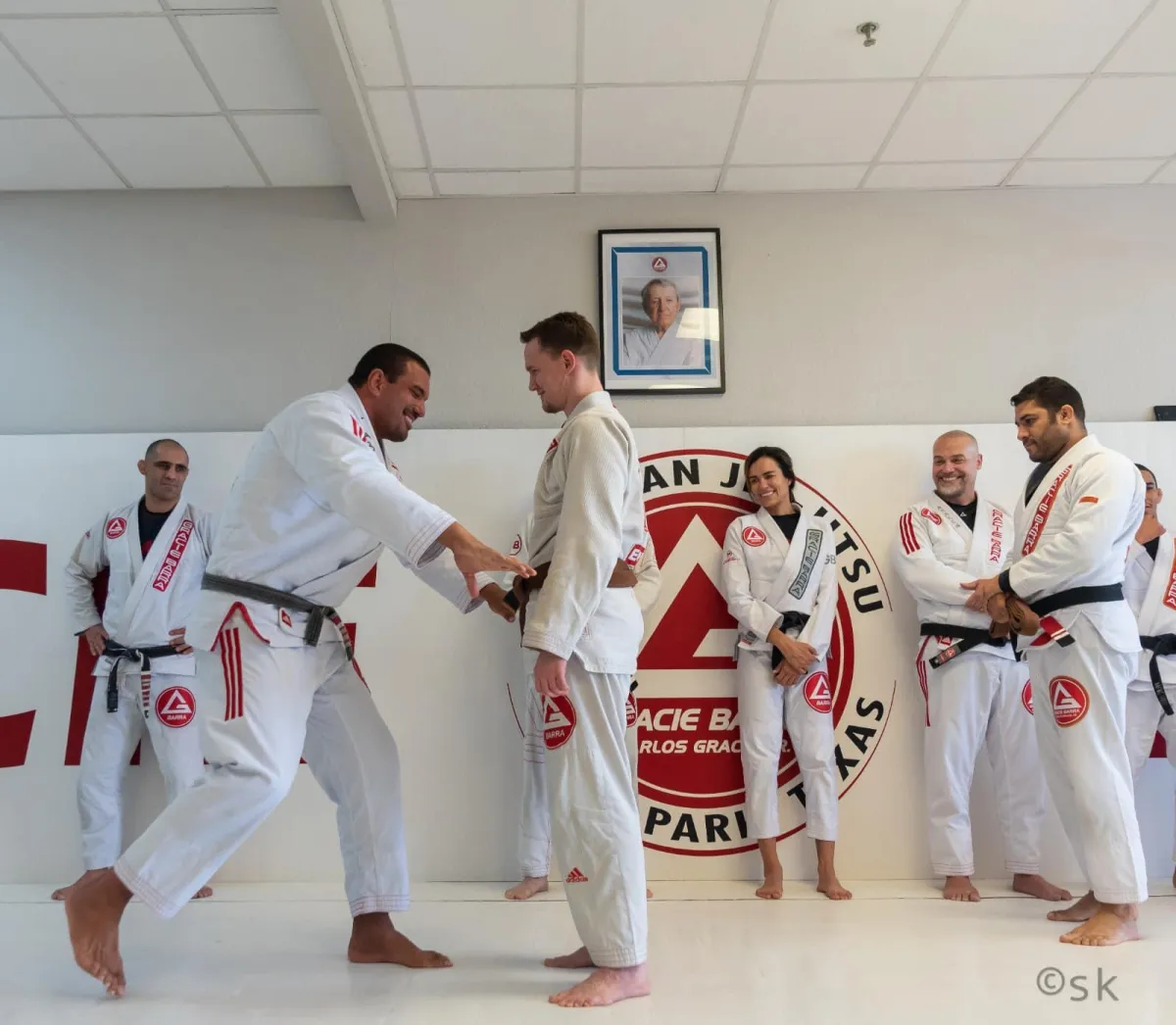 Group of our Brazilian Jiu-Jitsu students observing their instructor demonstrate a new technique.
