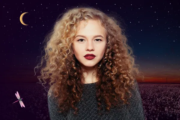 Visit Misty at Mistykal Hair Designs in Lubbock, Texas for a perm like the one featured. A Caucasian woman with brown-gold locks, permed to perfection and curling gracefully around her shoulders. The backdrop is the beautiful West Texas night sky and the signature Mistykal Hair Designs crescent moon and dragonfly.