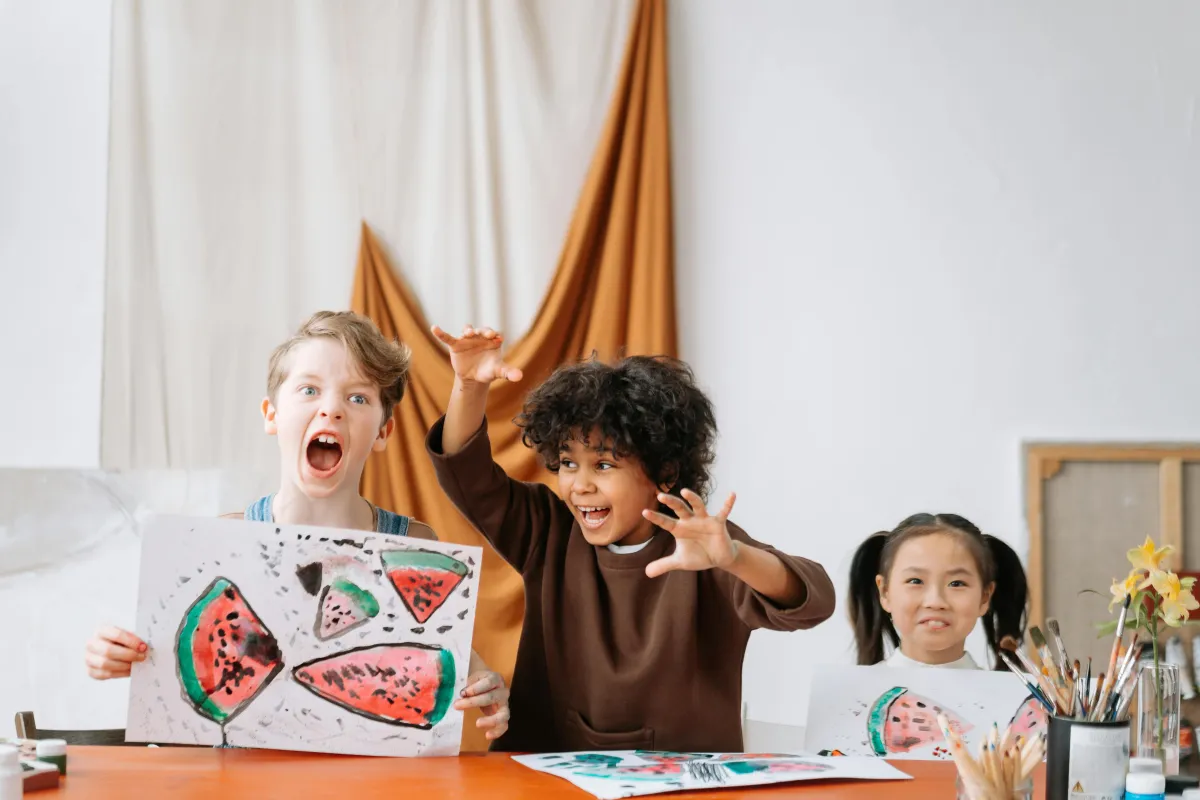 Kids displaying art at a table