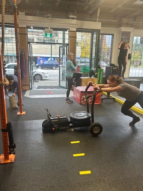 Woman pushing a sled in the gym
