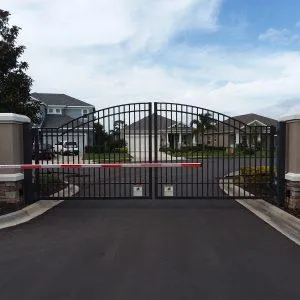 Custom double swing aluminum driveway gate installation in Lakewood Ranch, adding security and curb appeal.