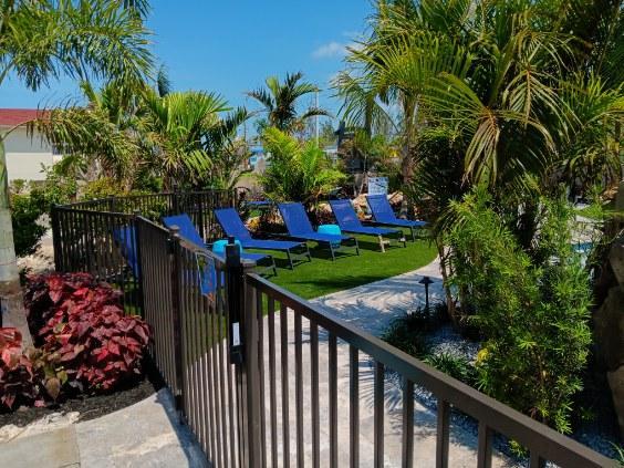 Aluminum pool fence installation in Sarasota with gate, enhancing safety and backyard relaxation area.