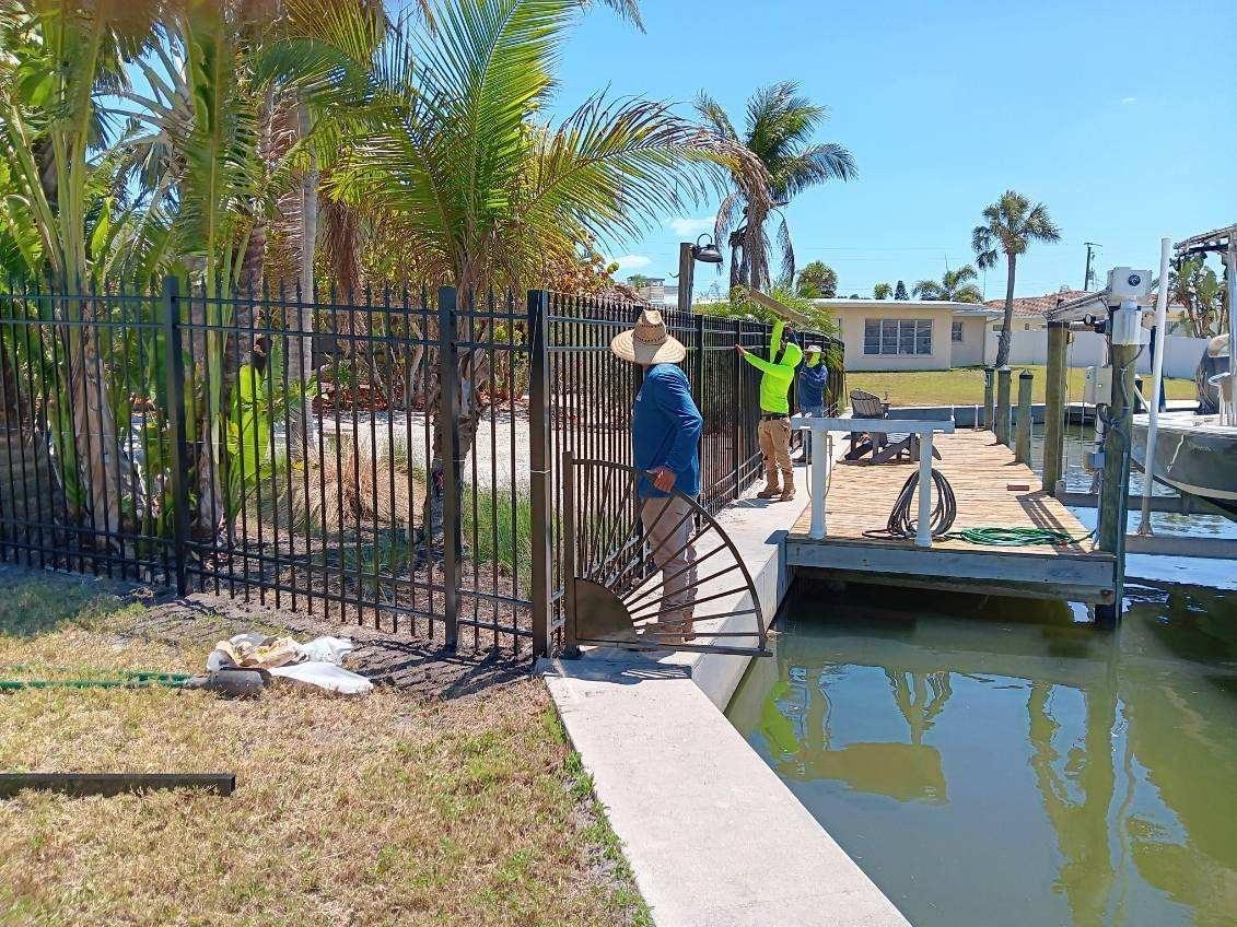 Black aluminum fence installation near waterfront in Bradenton, combining durability with scenic property views.