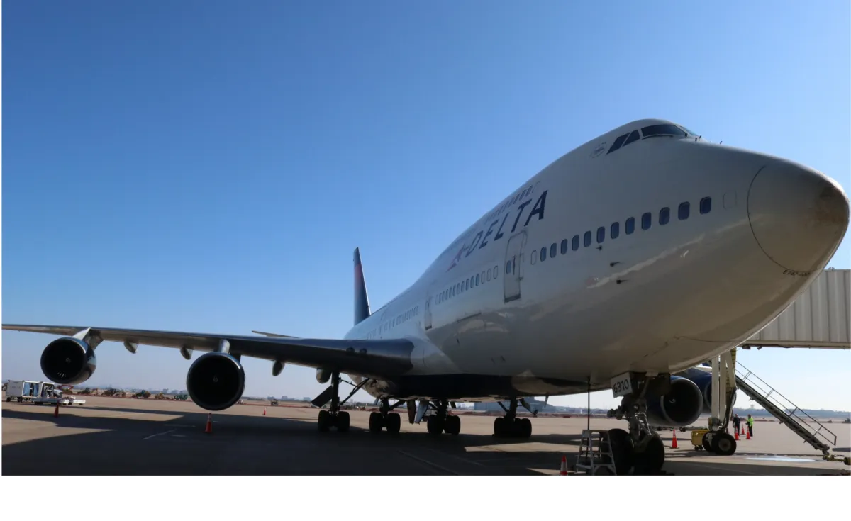 Delta airplane at airport gate.