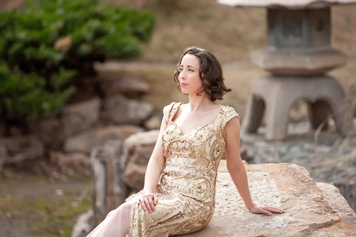 a woman wearing a gold dress