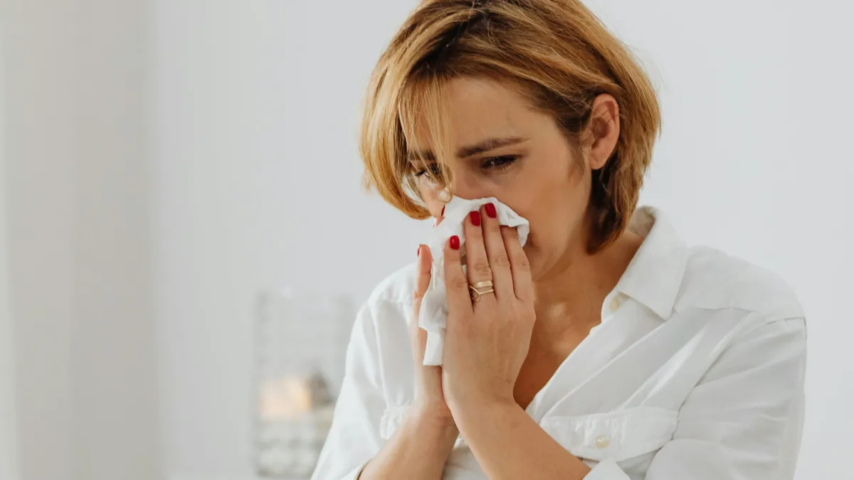 woman sneezing