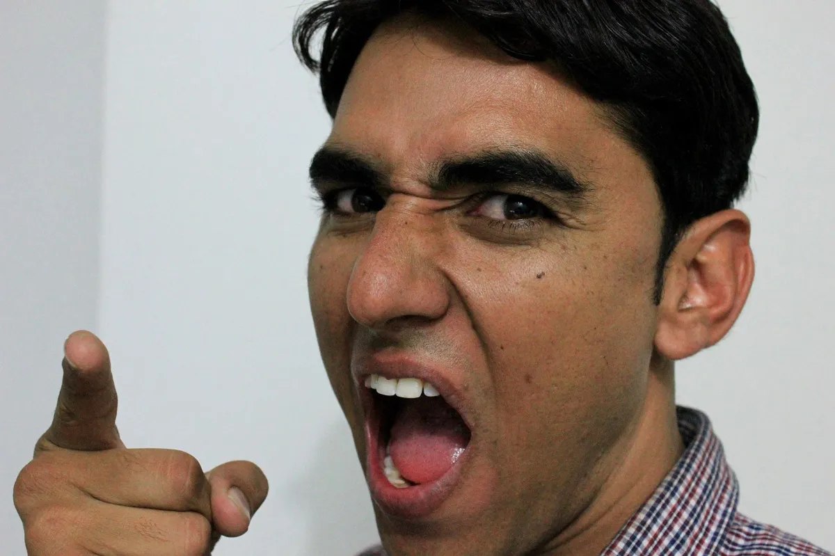 Angry man yelling and pointing finger