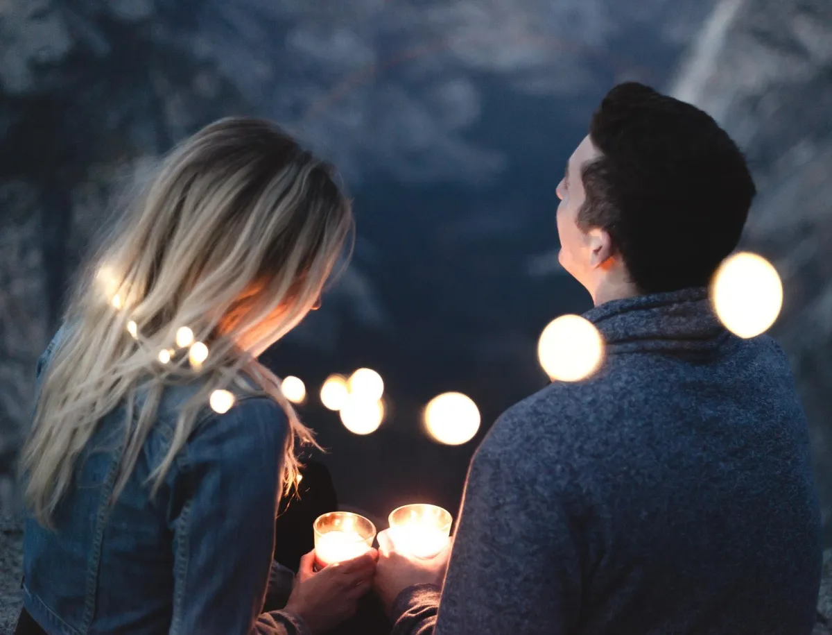 Woman holding man's hand looking down