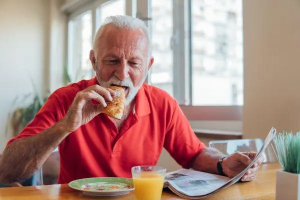  senior with dementia enjoy his bread