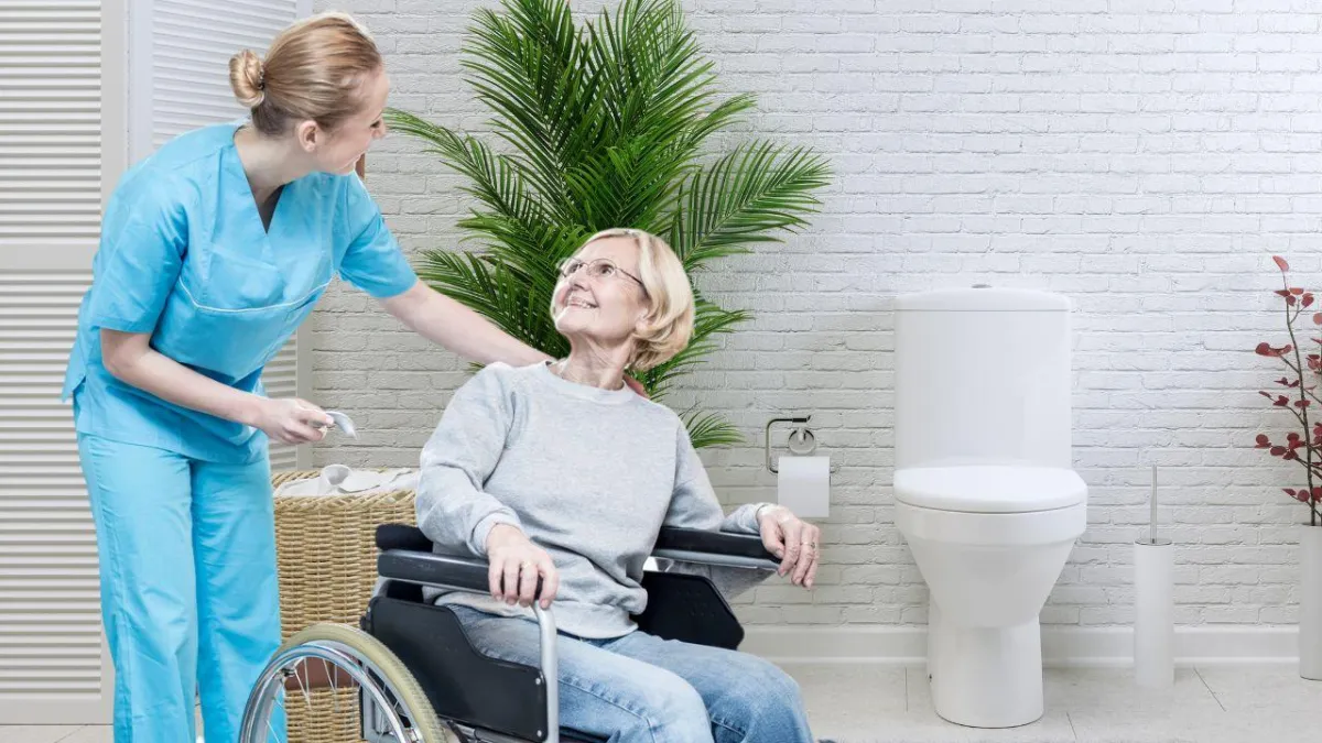 senior with assistant helping her in her toileting 