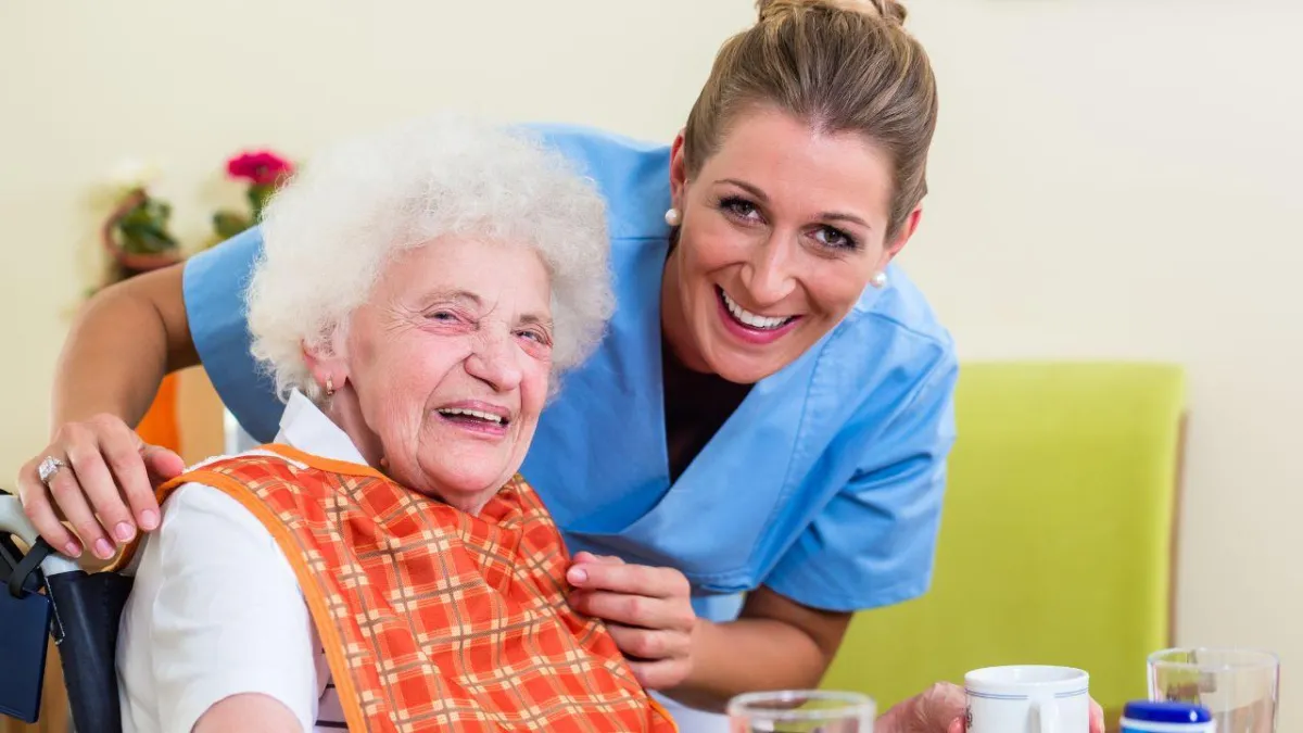 senior with dementia with his caregiving in eating