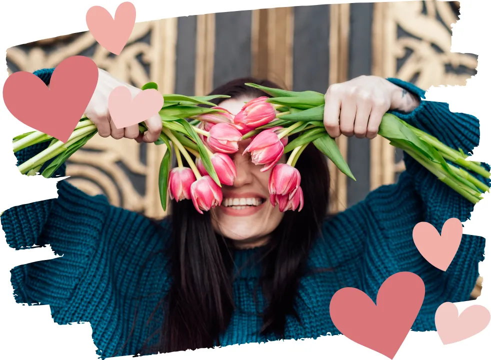 Happy midlife woman holding flowers and smiling, embracing confidence and joy during perimenopause. Women's wellness, hormone balance, and self-care in midlife.