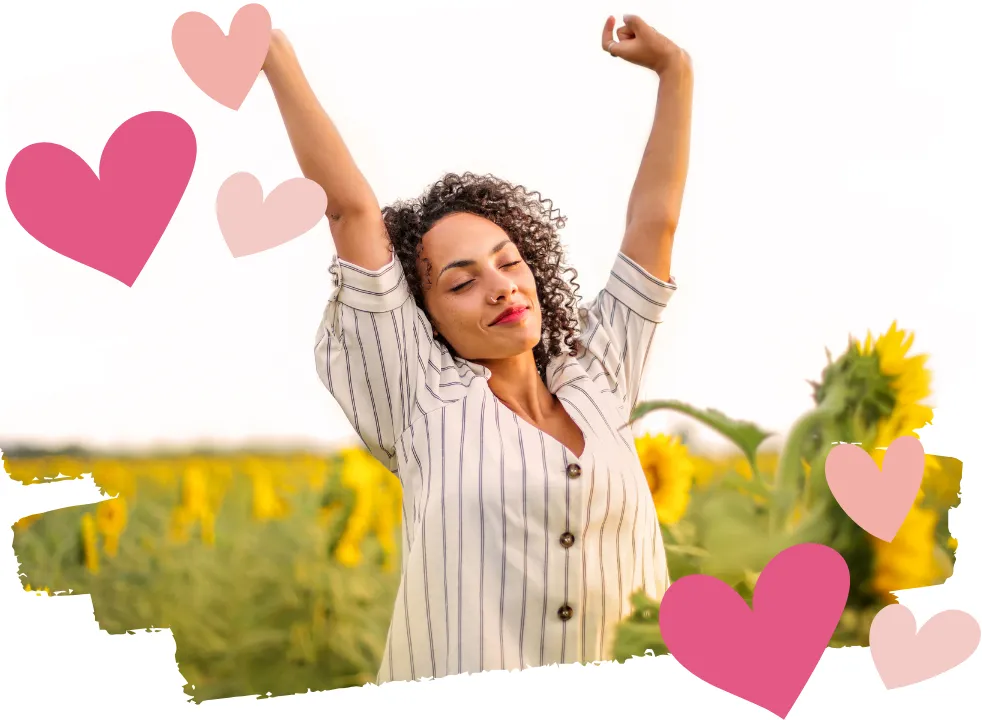Midlife woman stretching with arms raised in a sunflower field, symbolizing renewed energy, vitality, and empowerment during perimenopause.