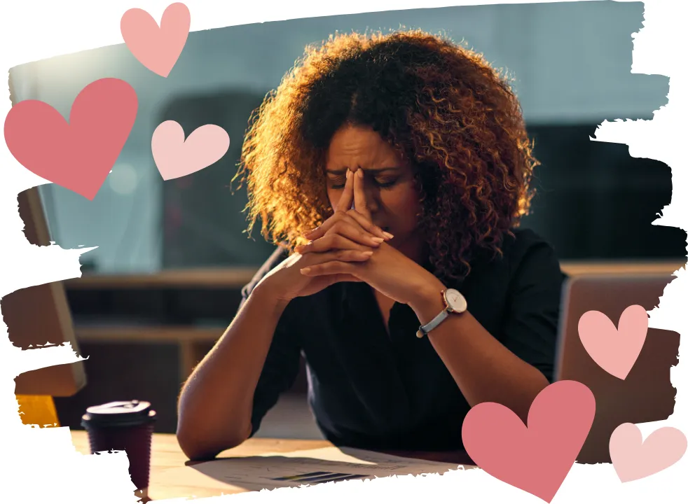 Midlife woman sitting at her desk with her face in her hands, feeling overwhelmed and unable to focus due to perimenopause-related brain fog and mental fatigue