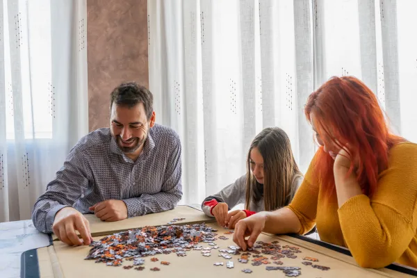 Family working on a puzzle at the table