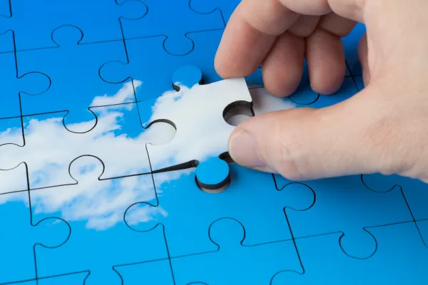 Close-up of calm hands placing a puzzle piece