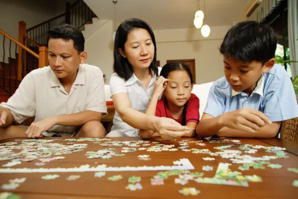 Close-up of hands placing a piece intentionally