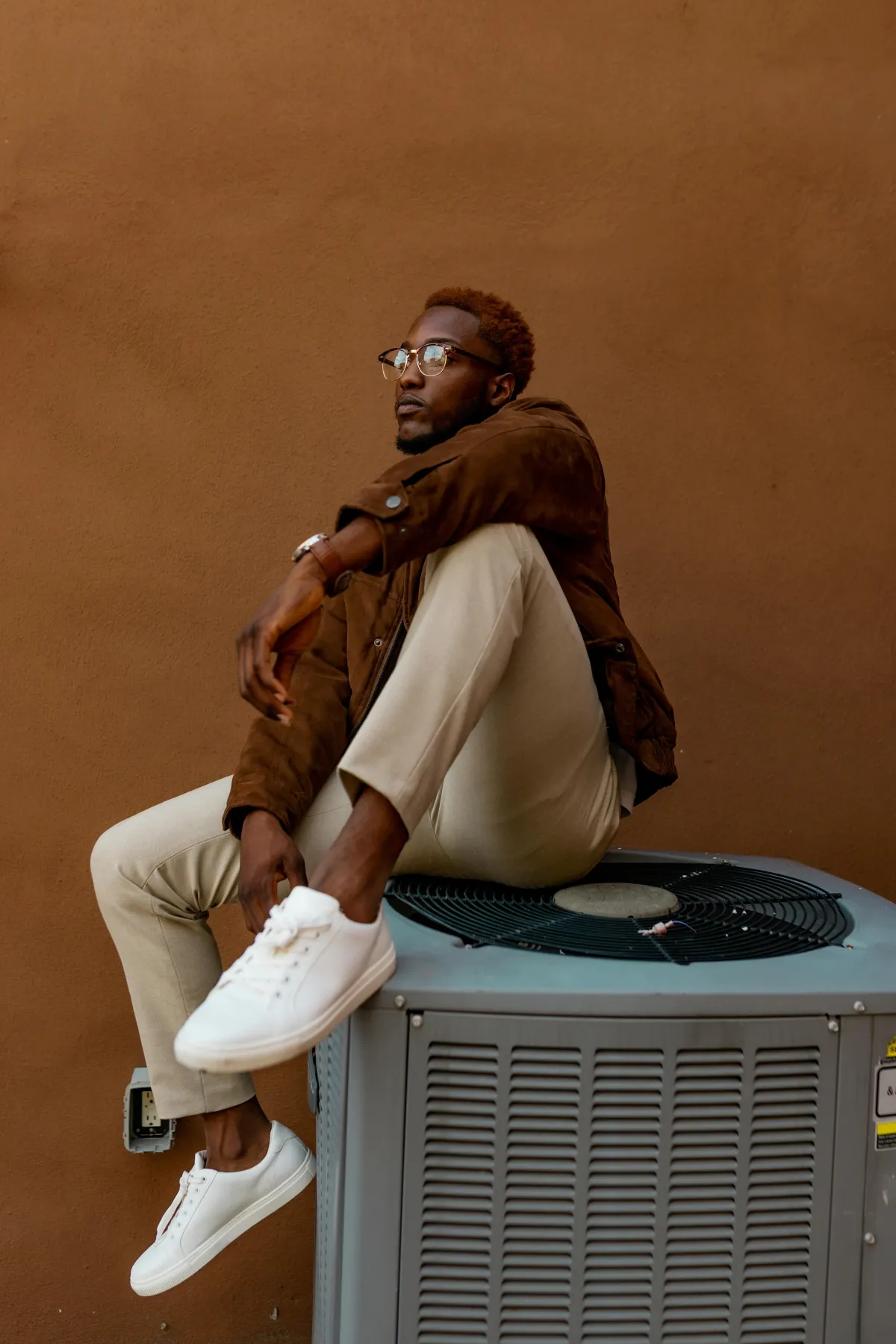 man on air conditioning unit