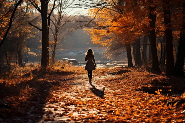 women walking down a bright yellow fall forest pathway
