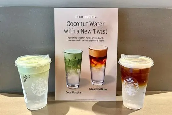 “Layered coconut-water Starbucks drink with matcha cold foam in a clear cup.”