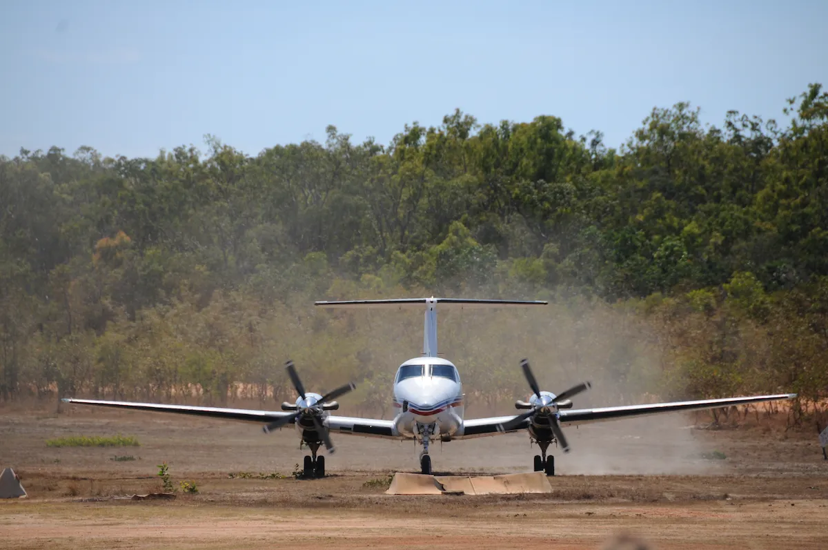 royal flying doctor plane landing on a remote dirt runway