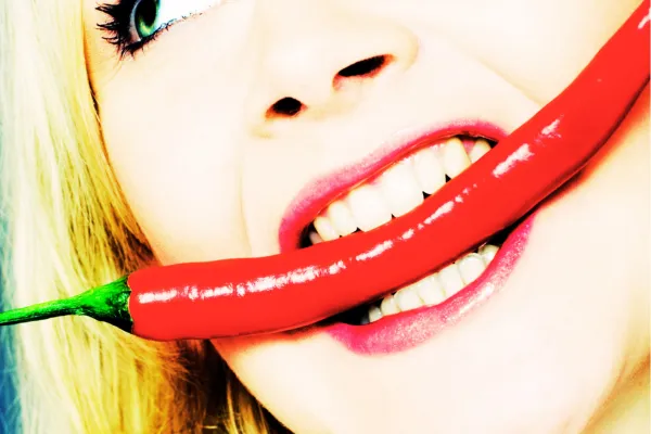 woman eating spicy pepper on the riverwalk