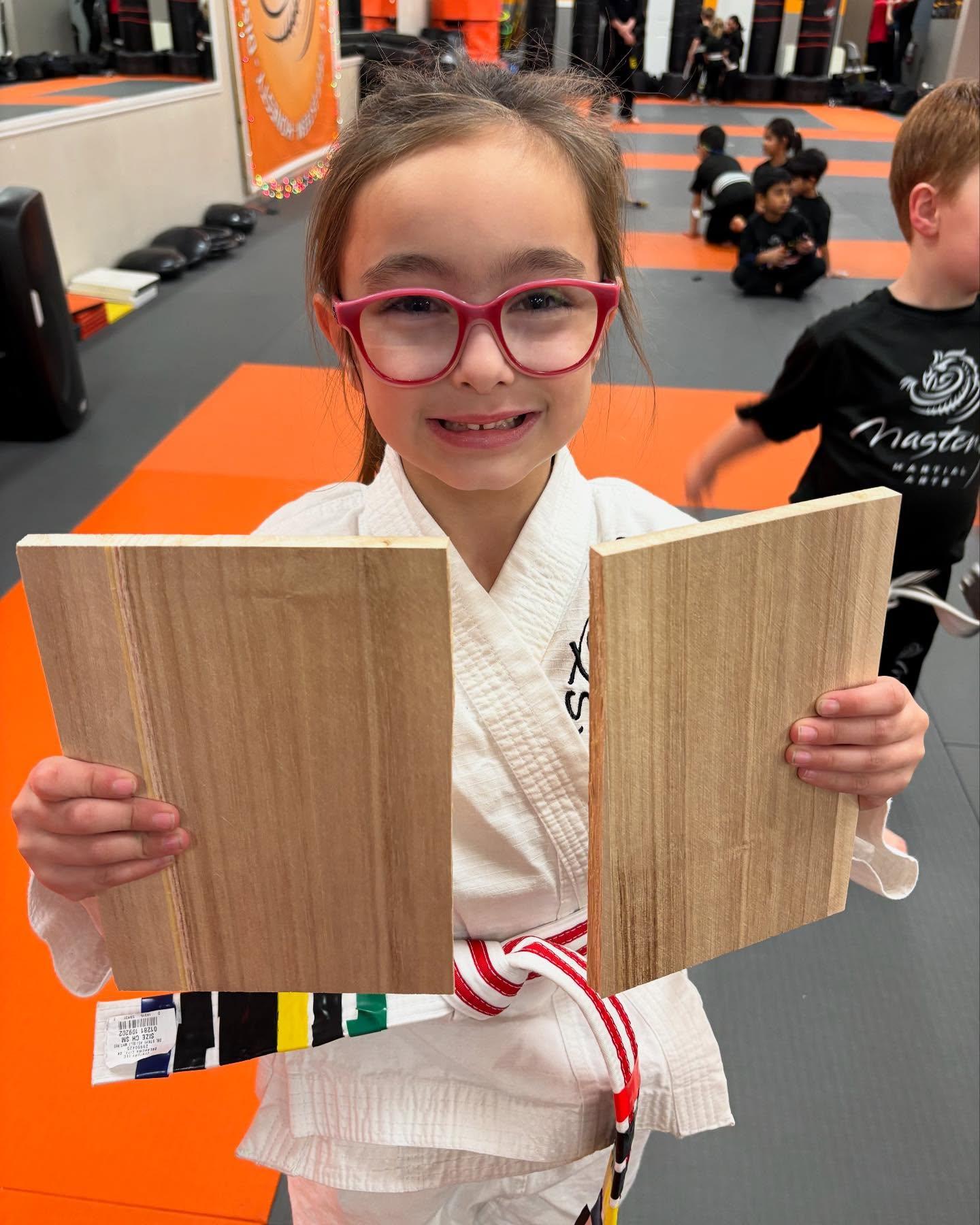 Mastery child focusing on the pads in a self defense stance