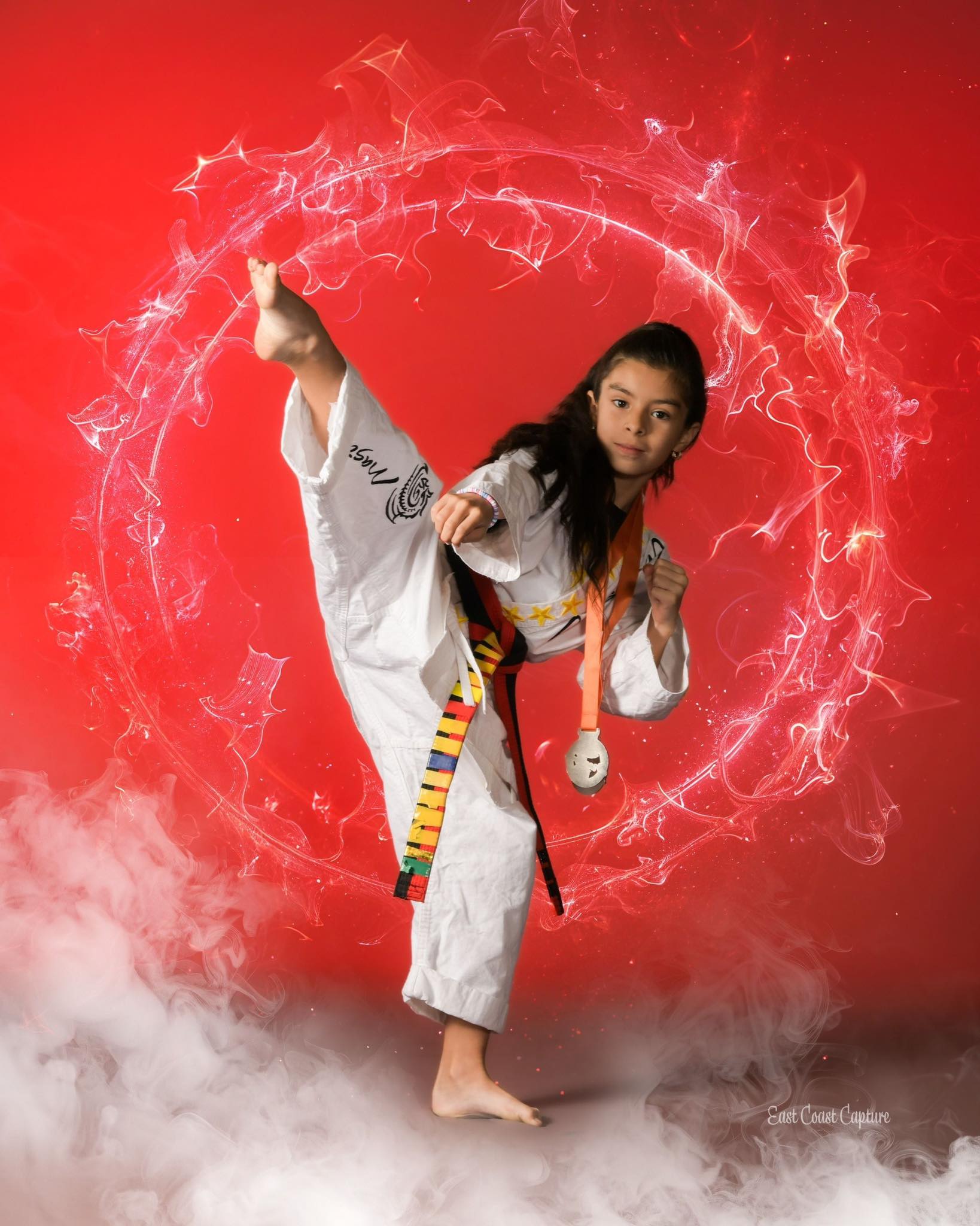 young girl in a white Martial arts uniforming kicking