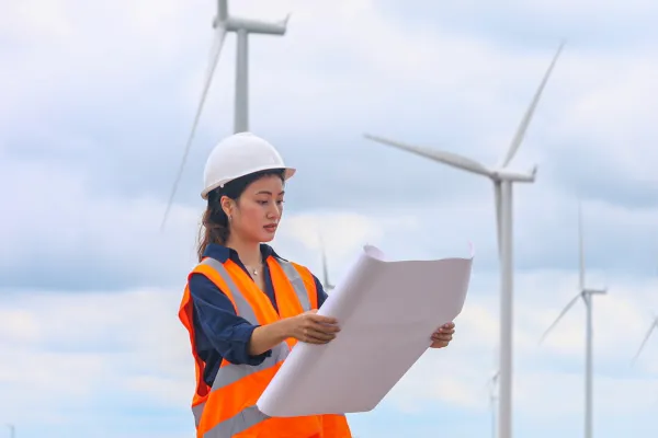 engineer in front of wind farm