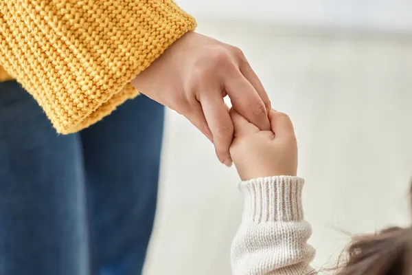 mom and kid holding hands