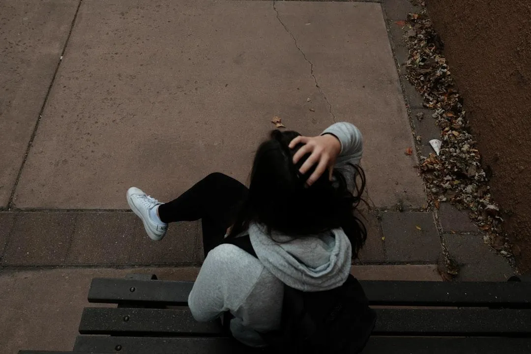 Woman covering head with arm