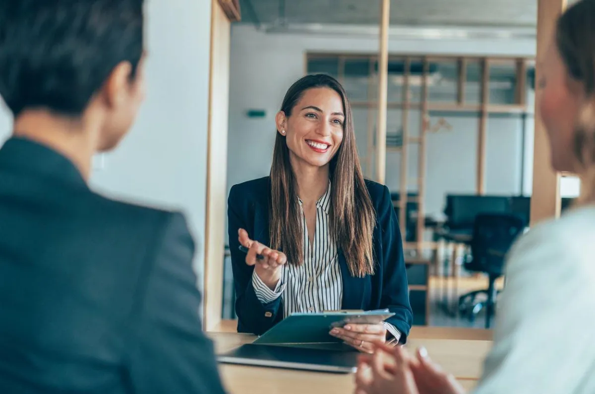 Person giving a presentation to a team in a conference room