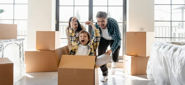Family with moving boxes moving into a new home