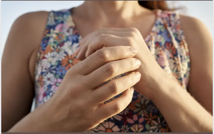 Image of a person gently tapping their hands, symbolizing the Emotional Freedom Technique (EFT) used in our coaching services, connecting to the holistic and nurturing approach of our website.
