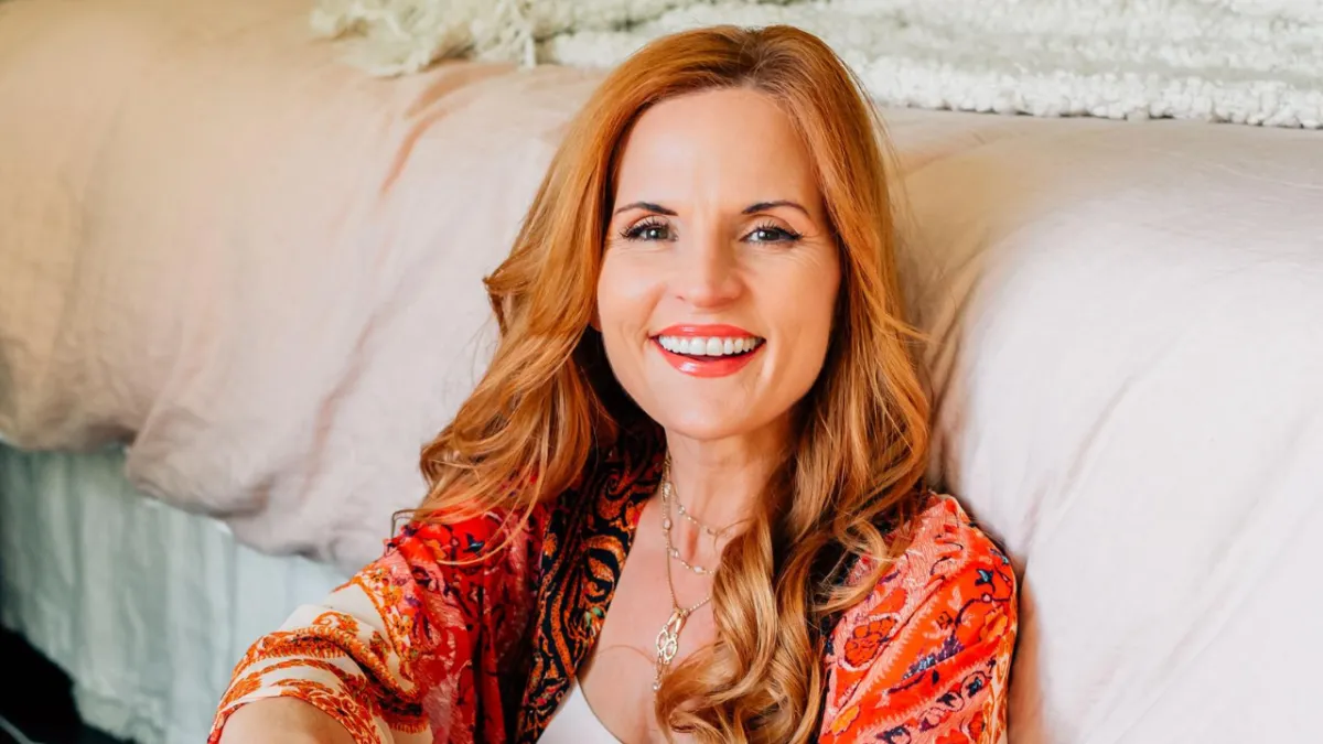 Annie Bauer, Founder of The Sovereign Mind, smiling in  bright colors talks about The Gifts of Imperfection by Brené Brown