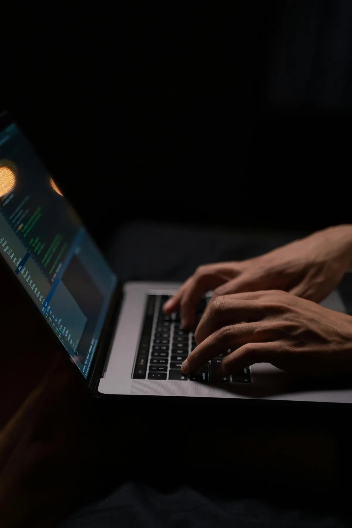 Hands typing on a laptop