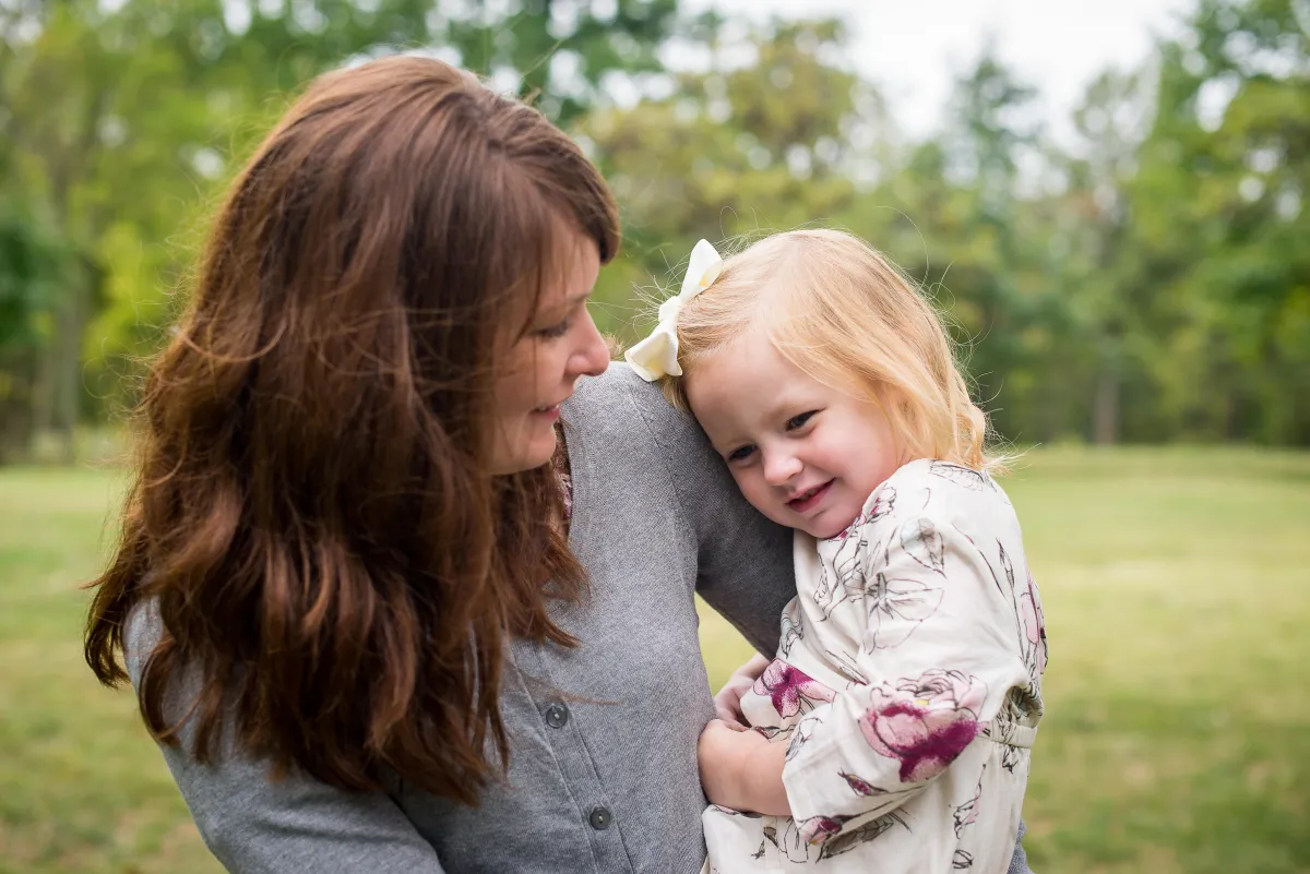 St. Louis Family Photographer mom holding daughter in field