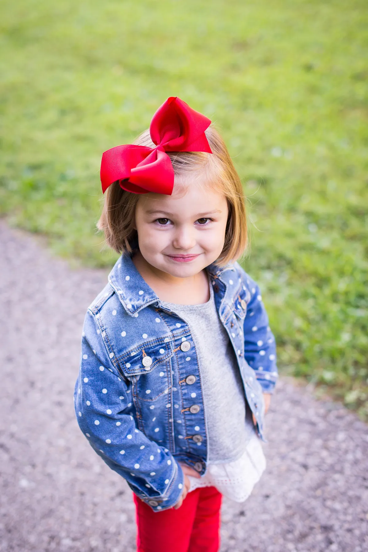 St. Louis Family Photographer little girl in field with big red bow