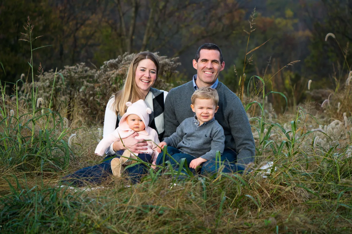 St. Louis Family Photographer mom dad brother and sister sitting in a field