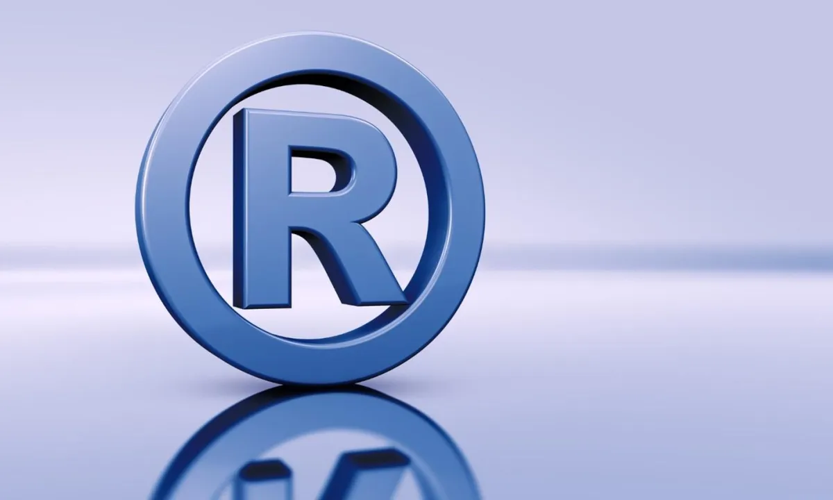 Blue registered trademark symbol on a reflective surface