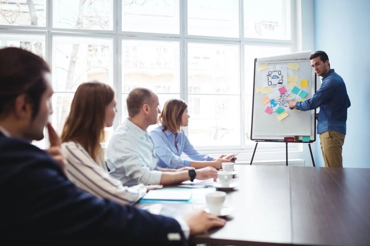 A business team discussing trademark concepts in a design meeting.