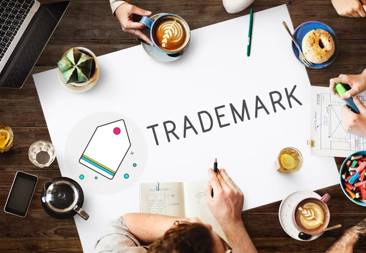 Colleagues gathered around a table discussing their brand’s trademark strategy.